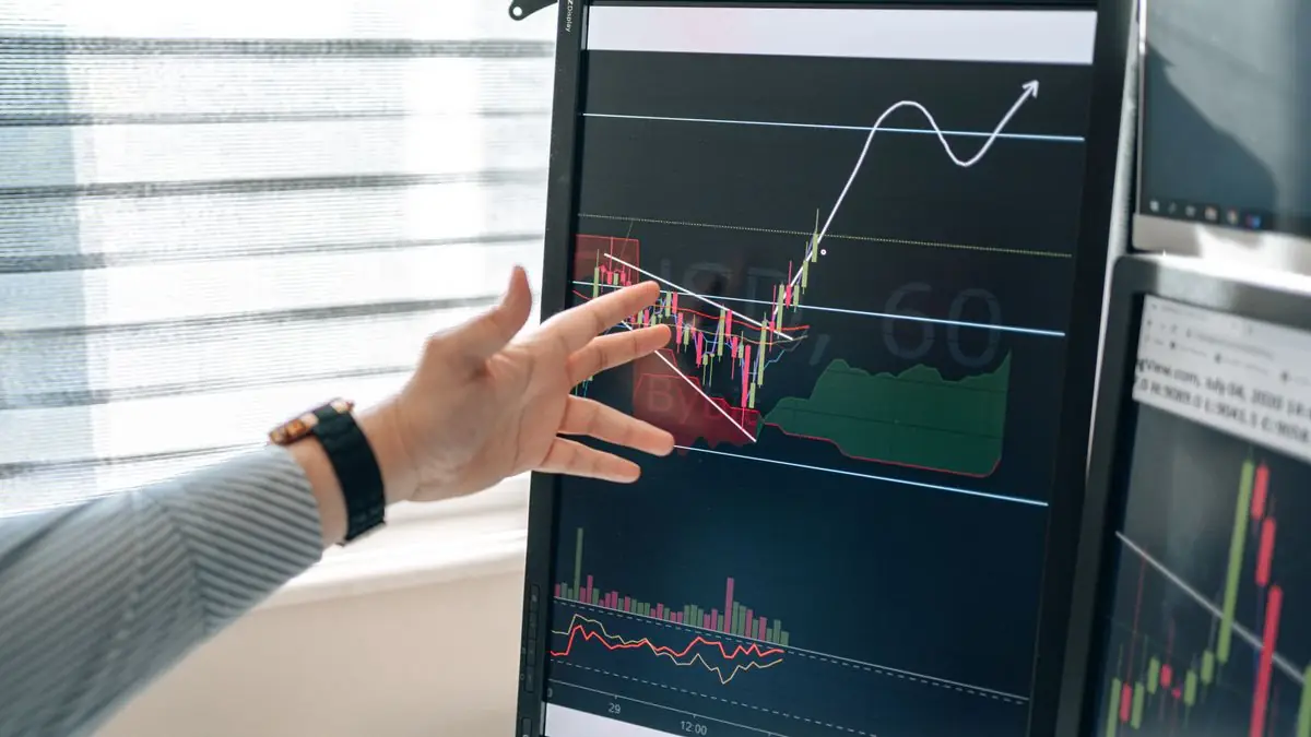 Financial charts on a dark monitor