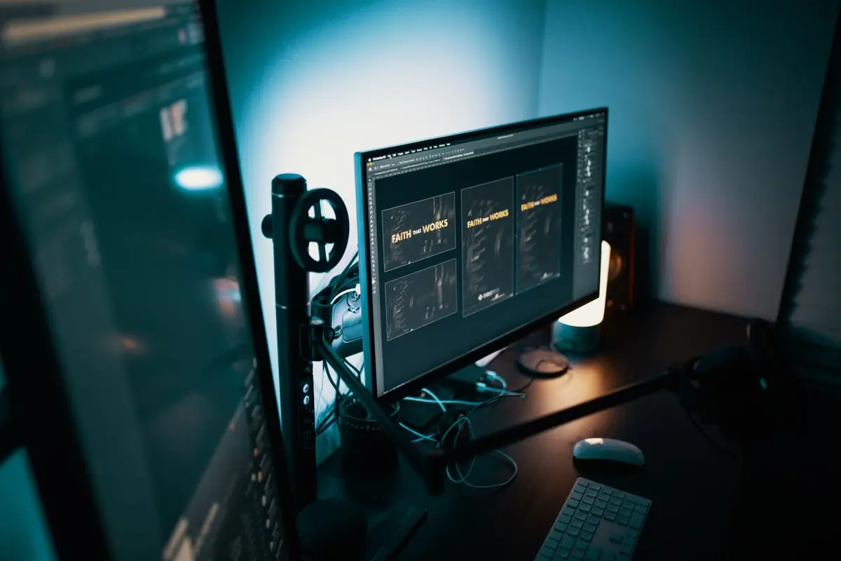 Designer working across dual monitors
