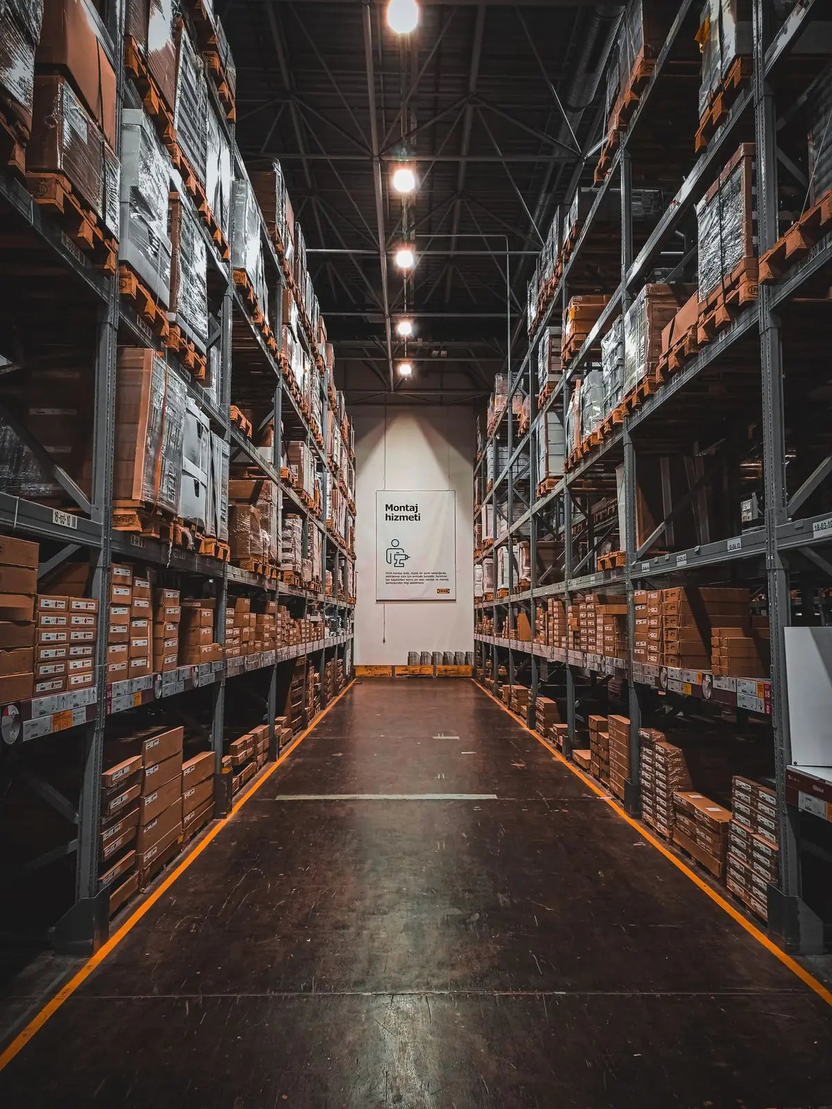 A dimly lit warehouse aisle